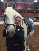 Lottie, a STAR Riders volunteer alumna, posing with a horse